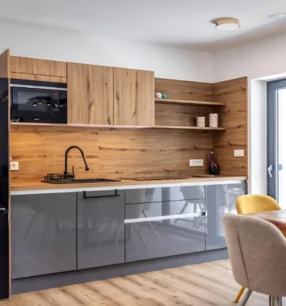 Modern, warm grey and wood kitchen in Bled apartment
