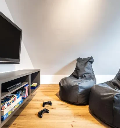Gaming room of Bled apartments with gaming console and two beanbag chairs